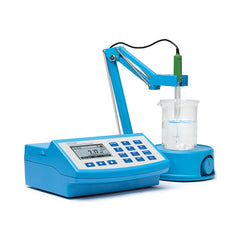 A Hanna benchtop photometer with a blue body and digital display, equipped with a pH meter probe and a beaker on top.