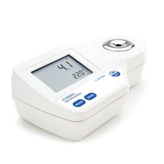 A Hanna Digital Refractometer Hanna HI96801 for Sugar with a digital screen, buttons for operation, and a sample dropper.