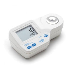 A digital refractometer HI96841 with a clear LCD screen, display window, and measurement control buttons, primarily white in color. Labelled with beer Refractometer.